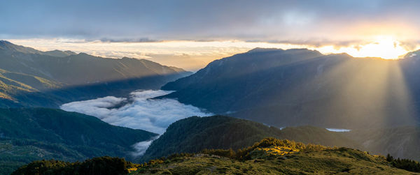 Scenic view of snowcapped mountains against sky during sunset