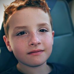 Close-up portrait of boy sitting in car