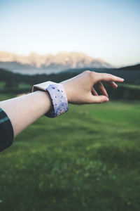 Close-up of woman hand on grass