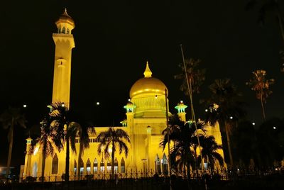 Illuminated building against sky at night