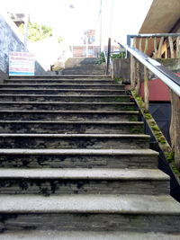 Low angle view of staircase amidst buildings in city