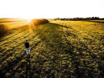 Rear view of person standing on field