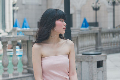 Young woman looking away at balcony