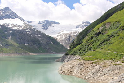Scenic view of lake and mountains against sky