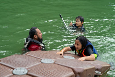 Siblings sitting in boat