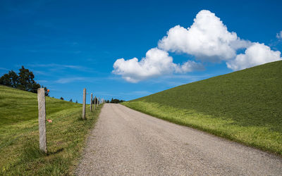 Empty road along countryside landscape