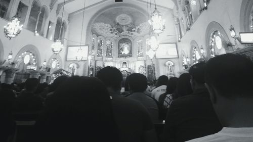 Crowd in illuminated cathedral