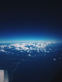 Aerial view of sea against blue sky