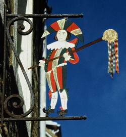 Low angle view of cross hanging against sky