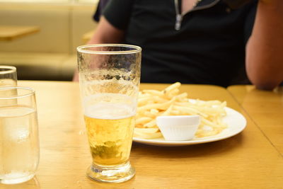 Close-up of beer glasses on table