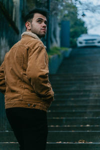 Portrait of young man walking on street