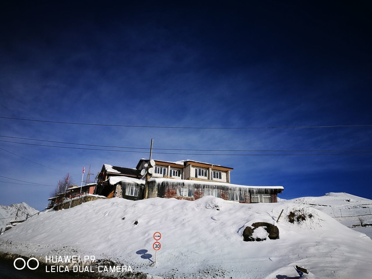 SNOW COVERED BUILT STRUCTURE AGAINST SKY