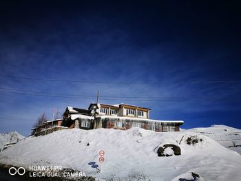 Houses against sky during winter