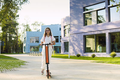 Portrait of girl with electric scooter
