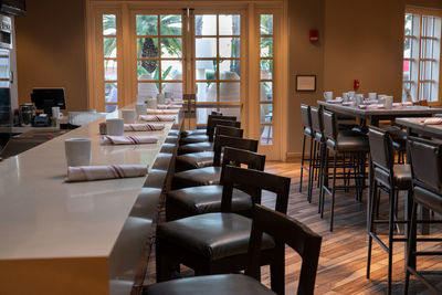 Empty chairs and tables in restaurant