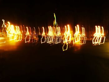 Low angle view of lit lights at night