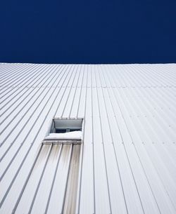 Low angle view of roof against clear blue sky