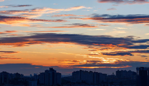 A beautiful sunrise with brightly fiery solar tongues breaking through the clouds 