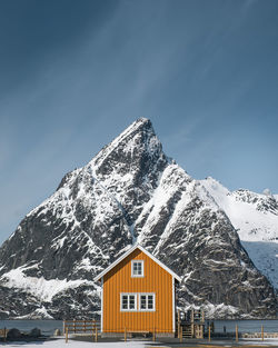 View of log cabin against mountain