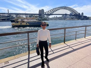 Lady standing in front of sydney harbour bridge