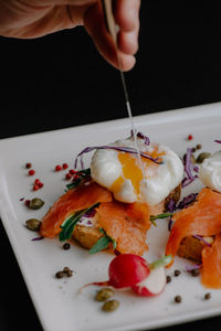 Close-up of person holding breakfast on table