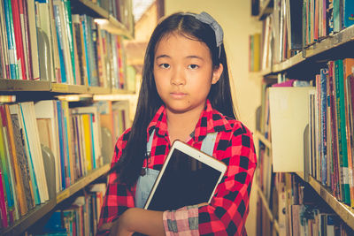 Portrait of girl holding digital tablet