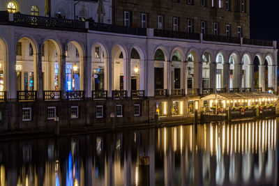 Illuminated buildings in water at night