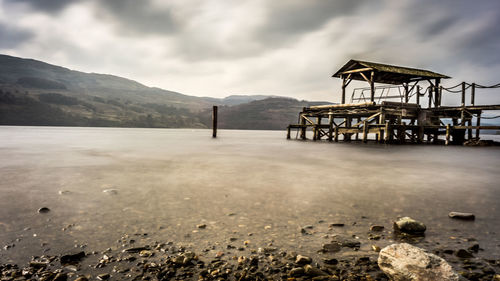 Lifeguard hut on land against sky