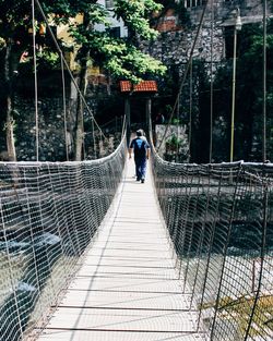 Man standing on footbridge