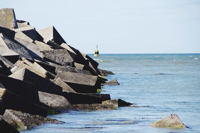 Scenic view of seawall against clear sky