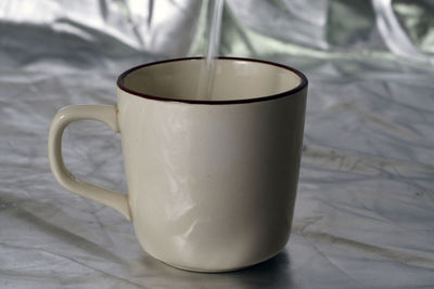 Close-up of coffee cup on table