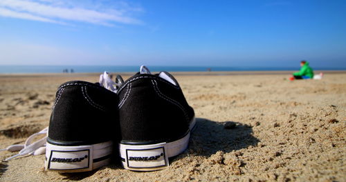 Close-up of man on beach against sky