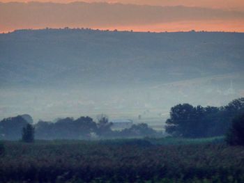 Scenic view of landscape against sky during sunset