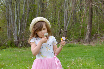 Full length of a girl holding flower