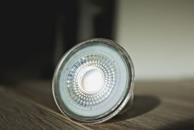 Close-up of illuminated lamp on table