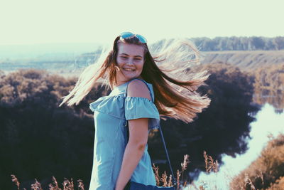 Portrait of a smiling young woman standing outdoors