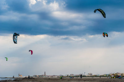 People parasailing against sky