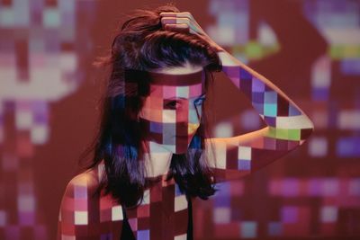 Close-up of woman photographing illuminated lighting equipment