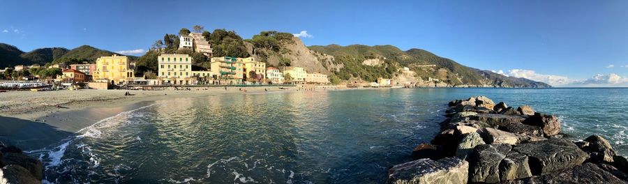 Panoramic view of sea and buildings against sky