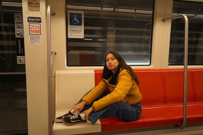 Portrait of woman sitting on train