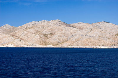 Scenic view of sea against clear blue sky