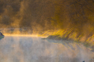 A beautiful spring river landscape with morning fog.