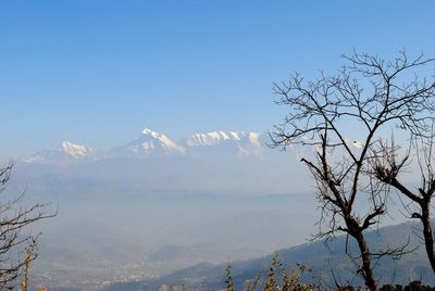 Scenic view of snowcapped mountains against clear blue sky