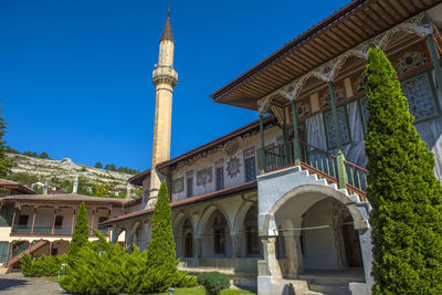 Low angle view of building against clear blue sky