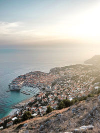 High angle view of sea and cityscape against sky