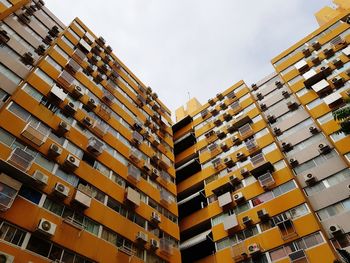 Low angle view of yellow buildings in city