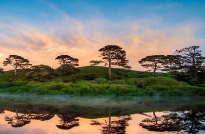 Scenic view of lake against sky at sunset