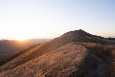 Scenic view of mountains against clear sky during sunset