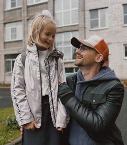 Portrait of smiling couple standing in city