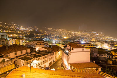 High angle view of illuminated buildings in city at night